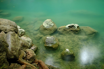 stone on waterfall in forest