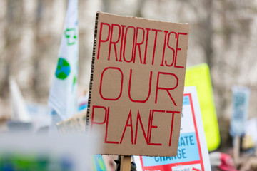 People with banners protest as part of a climate change march