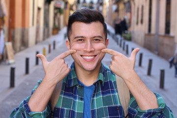 Man forced to smile outdoors 