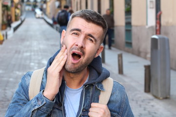 Unhappy man suffering from bruxism 