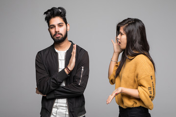 Indian young couple quarreling isolated on gray background