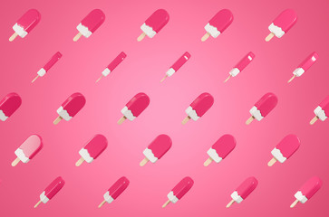 Pattern made of flying glossy  pink lolly ice cream on the pink background.