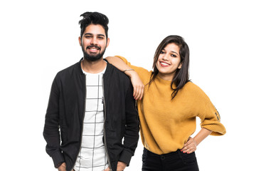 Portrait of beautiful young indian couple smiling isolated on white background