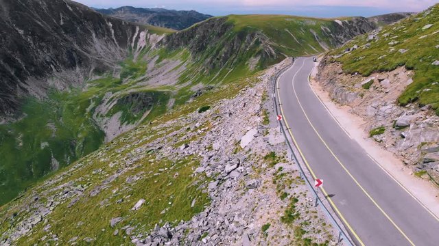 Aerial winding road with incredibly beautiful views on Transalpina, cars and motorcyclists on road. Romania mountain, travel, adventure concept, motorcyclists way, vacation place, mountains top Europe
