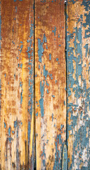 old wooden fence with cracked blue paint