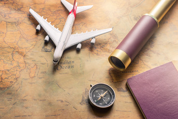 Notepad for note with passport, binoculars, pencil, compass, airplane on paper map for travel adventure discovery image