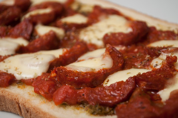 closeup of homemade Bruschetta with chorizo in a white plate