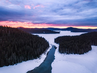 Winter landscape aerial drone panoramic photo over Shiroka poliana lake in Rhodope mountain, Bulgaria