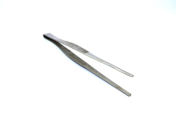 Closeup of dirty medical pincette isolated on white background.