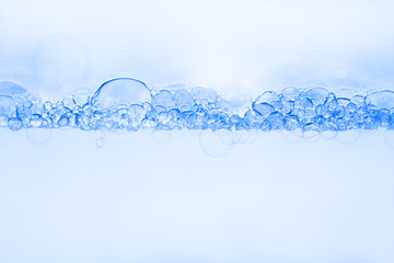 Transparent gel with bubbles close-up. The texture of gel cream. Oxygen bubbles in clear blue...
