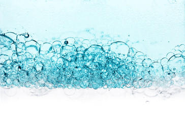 Transparent gel with bubbles close-up. The texture of gel cream. Oxygen bubbles in clear blue...