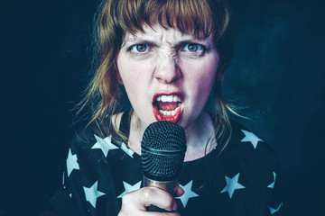 Young woman singing a song with a microphone