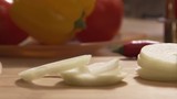 Close-up - Beautiful Onion Rings Falling While Cooking In A Restaurant Kitchen. Scene. Slices of onion close-up