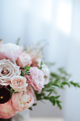 Spring bouquet of mixed flowers on vintage gray wall background behind