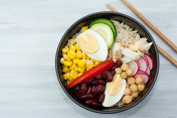 Bowl with vegetables, rice and fish.