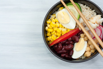 Bowl with vegetables, rice and fish.