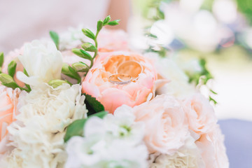 Wedding rings on top of a wedding bouquet