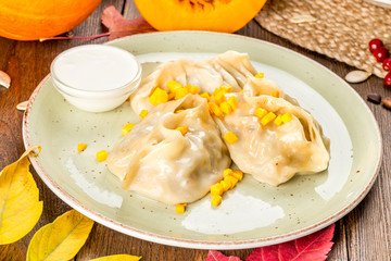 Pumpkin manti shot in decor on a wooden background