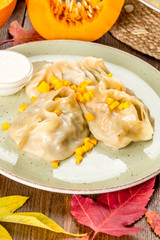Pumpkin manti shot in decor on a wooden background