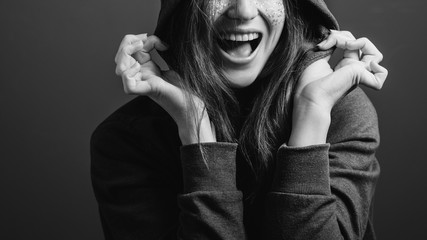 Joyful young woman expressing emotions. Excitement. Open mouth. Toothy smile. Black and white...