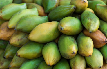 Fresh tropical mangoes  close-up. Fruit background. Healthy eating. Concept of autumn agricultural harvest (selective focus)