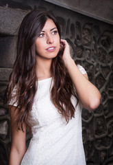 Fototapeta premium pretty brunette girl with brick wall background