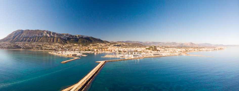 Aerial view of Denia port. The city and Montgo and Segaria mountains are in the background.