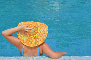 Real female beauty relaxing in swimming pool