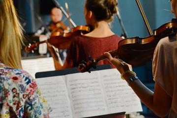 abstract blurred image. Actor violinist playing the violin strings. Musician plays a musical instrument on the concert stage  © Sanja