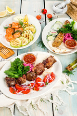 Grilled shashlik and vegetables removed on wooden background
