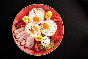 Fried eggs with vegetable and cheese.