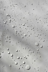 transparent sparkling water drops on white sheet