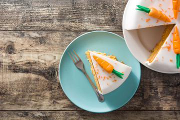 Sweet carrot cake slice on wooden table. Top view. Copyspace