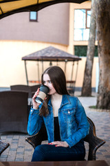 Beautiful girl drink coffee in cafe outdoors.