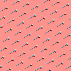 Seamless pattern of pale blue brush for washing dishes lying on living coral background Pop art style. Top view.