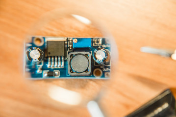 The photo of the electric circuit because of magnifying glass