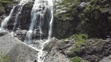 Close-up raging mountain waterfalls. Aerial view of giant waterfall flowing in mountains. Beautiful landscape
