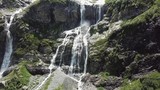 Close-up raging mountain waterfalls. Aerial view of giant waterfall flowing in mountains. Beautiful landscape