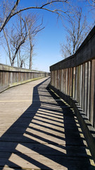 Fototapeta premium boardwalk and shadow pattern on a bright day