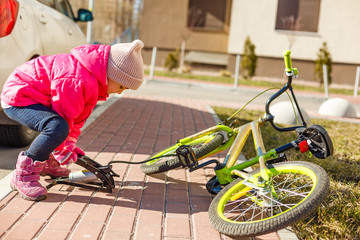 pumps a bicycle wheel for his sister