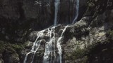 Close-up raging mountain waterfalls. Aerial view of giant waterfall flowing in mountains. Beautiful landscape