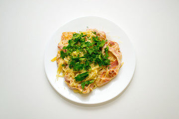 Pasta Carbonara. Cooking at home. Spaghetti with bacon, herbs and Parmesan cheese. Pasta Carbonara on a white background. Italian food concept.