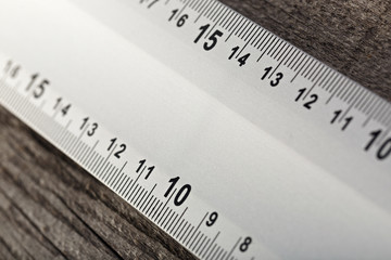 Measuring instrument on a wooden background. Tool for repair and construction.
