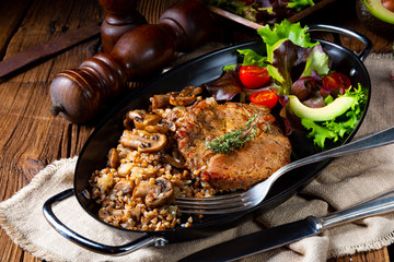 Pork steak with mushrooms and buckwheat groats and mango salad