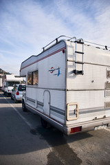 Caravan mobile home. Motorhome campers parked in caravanning parking. Summer vacation road trip. Leisure, resting, relaxing in Italy, coastal village of Imperia, Liguria.