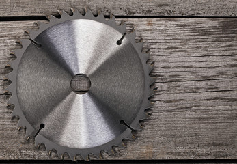 Circular saw on wooden background