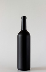 Wine black bottle are standing on gray background