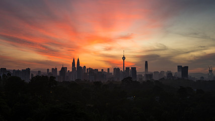 Fototapeta na wymiar KUALA LUMPUR, MALAYSIA - DECEMBER 22, 2018: Kuala Lumpur city skyline at sunrise with colourful skies.