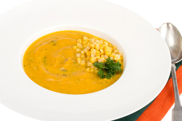 White plate with corn mash soup