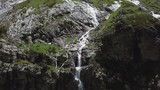 Close-up raging mountain waterfalls. Aerial view of giant waterfall flowing in mountains